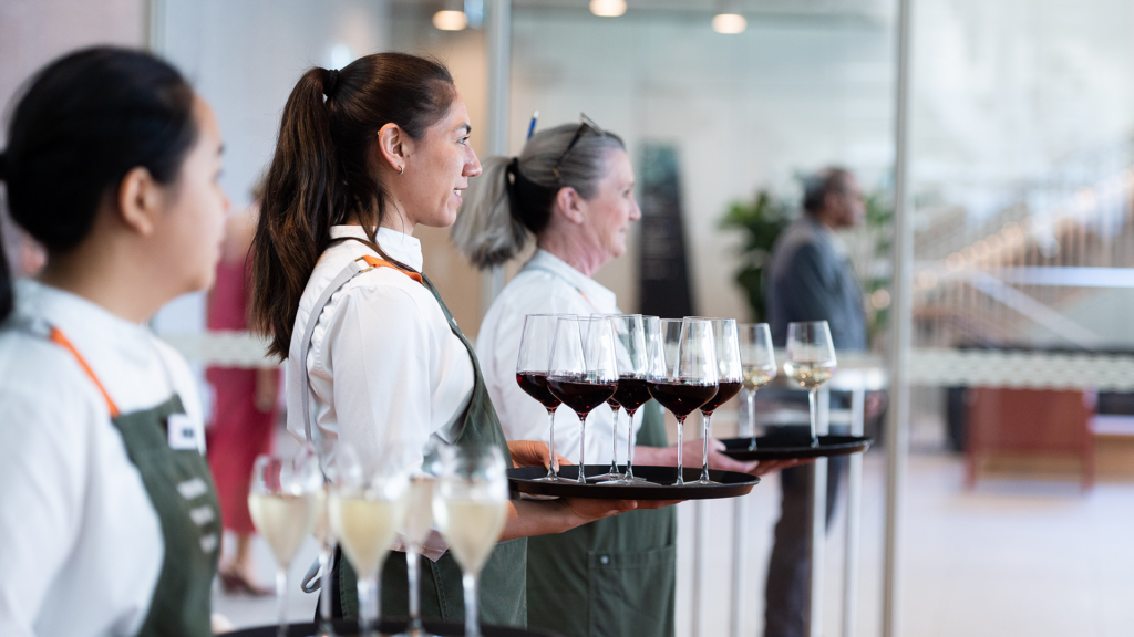 Waitresses serving drinks at a corporate event.