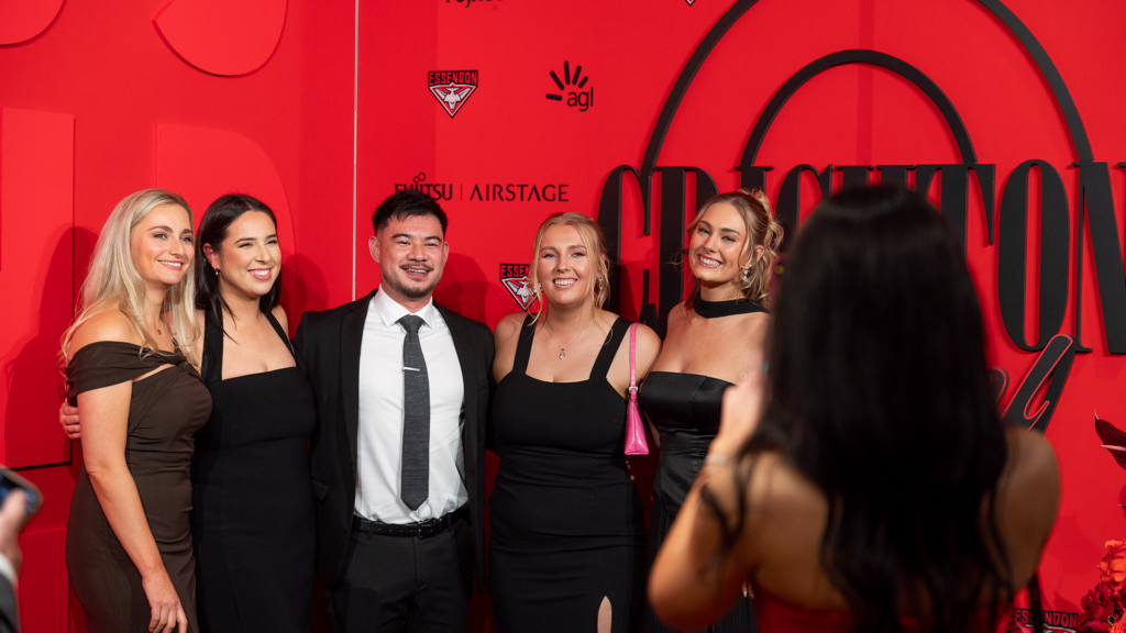 Guests posing for the camera at a corporate event.